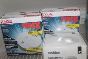 lot 223 image: Three smokeCarbon Monoxide detectors with Voice Alarm and one Wireless Smoke Alarm