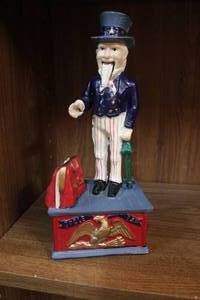 lot 19 image: Vintage Uncle Sam Mechanical Bank  - Cast Iron with paper see all pictures