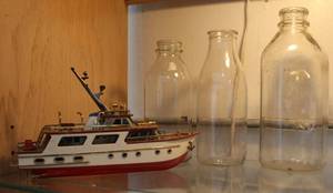 lot 55 image: Boat model and 3 vintage clear glass bottles