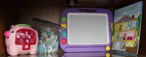 lot 67 image: Previously loved pig with coins drawing board and a couple puzzles