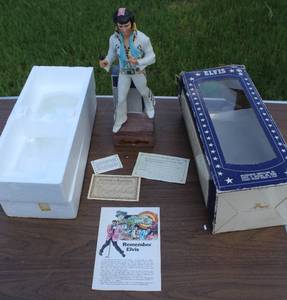lot 234 image: Elvis decanter with music box on it worked when posted stands about 15 inches tall