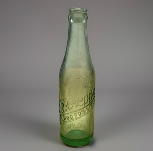 lot 128 image: 1951 Dr. Pepper 10-2-4 Soda Bottle Embossed Green