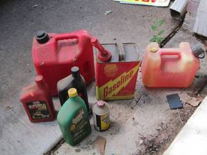 lot 244 image: qty 2 gas cans, gasoline can, various bottles of used oil