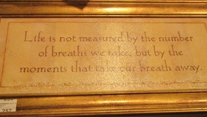 lot 257 image: Framed quote wall art -LIFE IS NOT MEASURED BY THE BREATHS WE TAKE, BUT BY THE MOMENTS THAT TAKE OUR BREATH AWAY