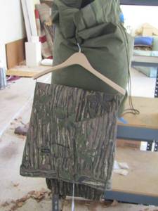 lot 277 image: Coleman red sleeping bag and Camo pants 46x31
