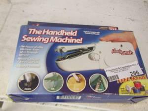 lot 296 image: the handheld sewing machine