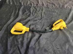 lot 82 image: Camco power grip dogbone electrical adapter 30Amp