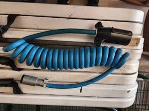 lot 140 image: Blue Ox 4 wire coiled electrical cable for towing vehicles with an RV