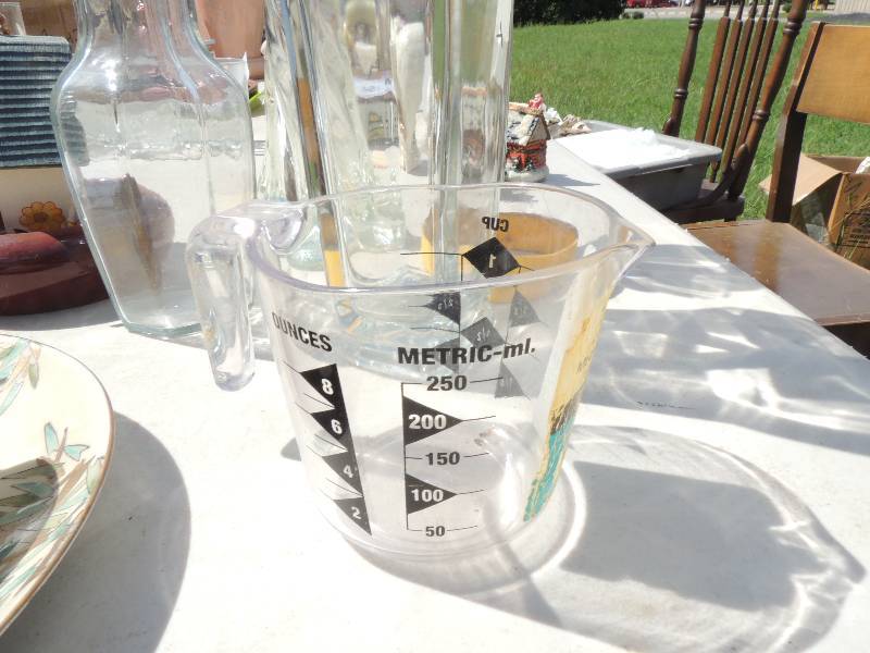lot 546 image: vase, bird house , measuring cup, ...