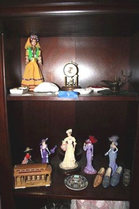 lot 3 image: Souvenir doll, shells, lady figurines, ceramic shoes, and cable car. See photos
