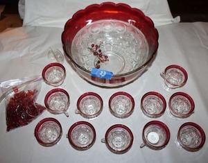 lot 23 image: Cranberry glass punch bowl set with red glass beads for decoration