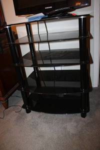 lot 89 image: Multi-tiered smoked glass table - 26x20x33tall. Matches TV stand in living room.