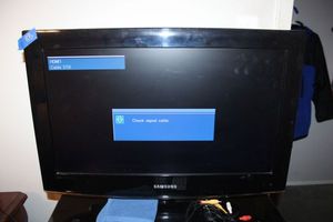 lot 88 image: Samsung TV model LN26A450C - powered on. ( not sure which is correct remote)