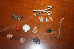 lot 102 image: Jewelry Misc. pins and pendants, (white heart pendant has color glimmers like opals but untested)