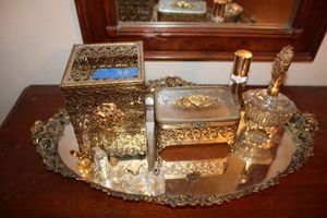 lot 98 image: Vanity set in gold with perfume bottles
