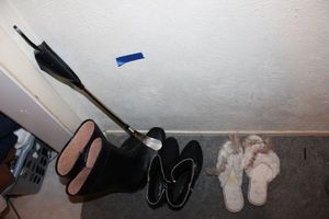lot 172 image: Black boots and slippers, plus long shoe horn
