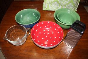 lot 192 image: Kitchen Pier One green bowls, Christmas polka dot bowl, 4 cup measuring cup and grater