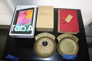 lot 229 image: Brass pocket change holders Spanish dictionary, Virginia Slims keychain, Samsung Galaxy S4 box only, and Asus tablet (untested - please preview)