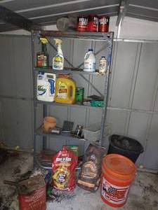 lot 325 image: Garden supplies, weed killer, orange bucket and more. Metal shelf as well (one shelf is rusted).