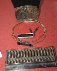 lot 235 image: Vintage promotional knife, Abacus marble weight, Boxcar Willie Belt Buckle, and more