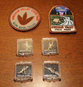 lot 76 image: Sterling silver dinosaur charms and  patches