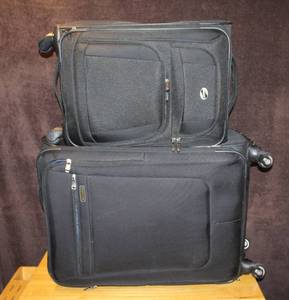 lot 336 image: 2 suitcases the larger one is ricardo  and the smaller one is American tourister
