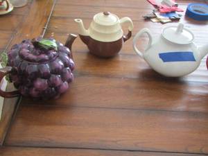 lot 47 image: TEA POTS -  Grape Tea Pot (PURPLE) , - White Tea Pot,  WHITE & BROWN TEAPOT, and  WHITE TEAPOT PAINTED WITH GRAPES   plus
