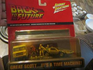 lot 24 image: BACK TO THE FUTURE  - Johnny Lightning NIB - FEATURING DeLOREAN TIME MACHINE, YELLOW PICKUP, FIGURES OF MARTY MCFLY & DOC BROWN