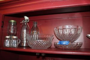 lot 66 image: Clear cut glass serving bowls, bottles and S&P shakers