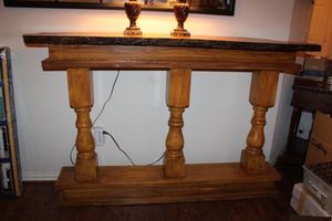 lot 20 image: Console table with tree slice on top. 69W x 15D x 42.5H, base measures 60W x 11D