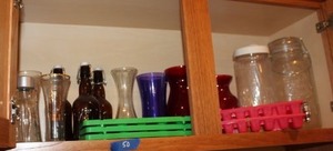 lot 50 image: Colored glass and clear vases, brown glass bottles and plastic ice trays