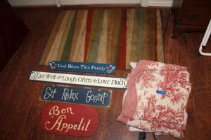 lot 90 image: Vintage red pattern valance curtains, wood signs, and entry size area rug
