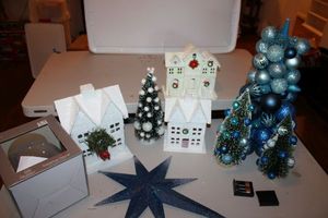 lot 108 image: Christmas decorations blue ornament trees, metal star, white houses, and glass glitter ball