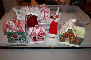 lot 10 image: Ceramic candy house, red and green houses, and white Christmas mini trees