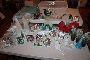 lot 11 image: Christmas village decorations with sleigh candle holder