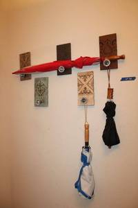 lot 34 image: Umbrellas with door knob wall art