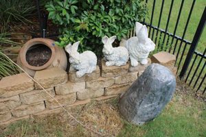 lot 174 image: Garden bunny statues, plastic fake stone rock, angled round planter