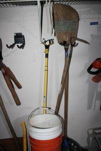 lot 275 image: Broom, yaed hoe, light changing pole, and 5 gal. buckets