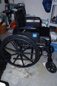 lot 14 image: Black wheelchair with 2 gel seat cushions