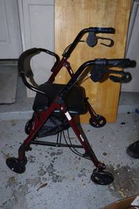 lot 264 image: Walker with brake handle, seat and storage compartment