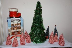 lot 111 image: Red and white ribbon candy trees and green Christmas tree decoration with Dickensville lighted house
