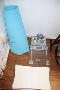 lot 212 image: Fitness lot Wii balance board, scale, ankle weights, yoga mat and handheld massager