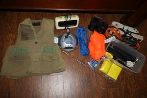 lot 251 image: Camping items taser, extension cords, lamps, alarm clock, fishing vest and more