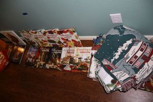 lot 254 image: Christmas books and recipe books, blanket, and table linens