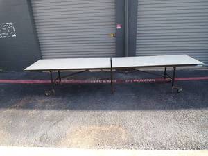 lot 14 image: Folding Rectangle Mobile Cafeteria Table w Particleboard Core & Powder Coat Frame. Open surface is about 30 W x 12 L x 29 H, and folded is about 23W x 30L x 82H