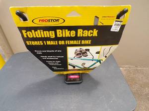 lot 19 image: Prostor Folding Bike Rack, Stores Male or Female Bike, Shelf for Helmet or Accessories.