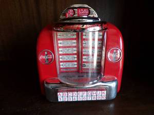 lot 50 image: 1996 Coca Cola Seeberg Wall-o-Matic Bank, Plays  Its The Real Thing About 6x2 34x5 12