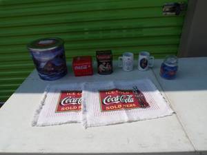 lot 72 image: Lot of Coca Cola Items, Including Placemats, Tins and Mugs, and 1 Large Popcorn Tin