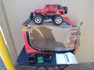 lot 41 image: New Bright Remote Control Jeep Wrangler, Full Function RC, Right Left Forward Backward Steering.