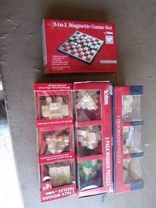 lot 93 image: Lot of 4 Totes Puzzle Packs, 3- 3 pack of Wooden Puzzles and 1- Magnetic Game